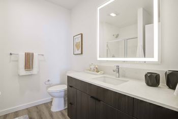 Baths include backlit vanity mirror